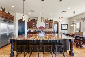 Kitchen in North Scottsdale horse property with granite island and custom cabinetry”