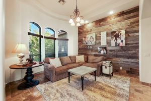 Bonus room with wood accent wall, tray ceiling, and natural light at 28025 N 156th Place in Scottsdale, currently used as a second living space