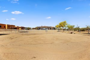 Horse turnout area with shade structure and split rail pipe fencing at 28025 N 156th Place in Scottsdale