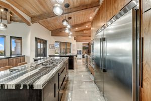 Chef’s kitchen at 6432 E El Sendero Rd featuring Fantasy Marble Countertops, gas cooktop, custom cabinetry, and built-in Thermador & Asco appliances.